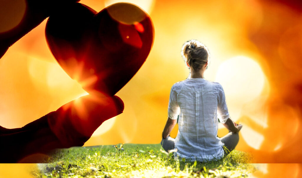woman meditates and a hand holding a heart floats in the sunset
